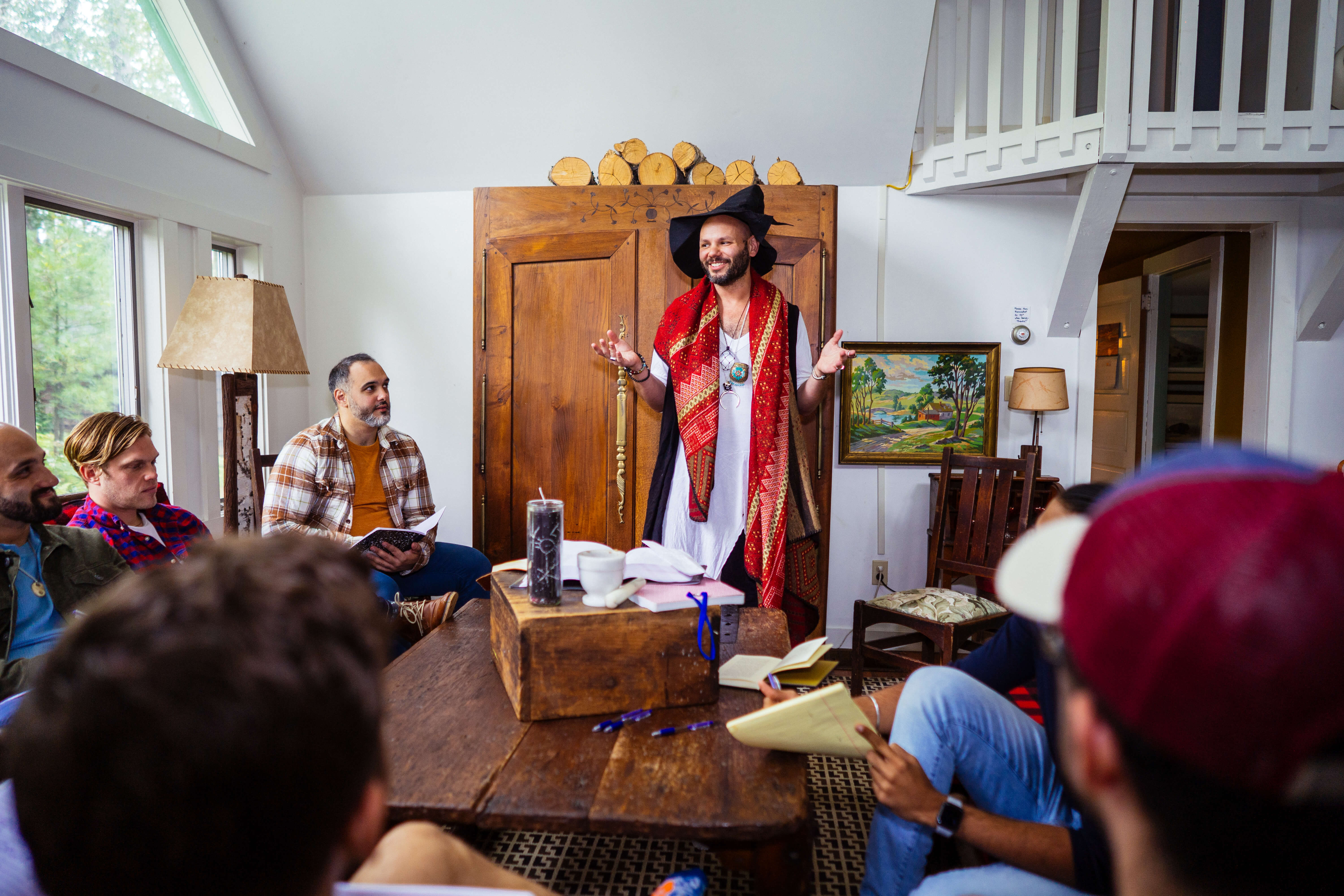 Workshop in session, queer facilitator speaking to a circle
