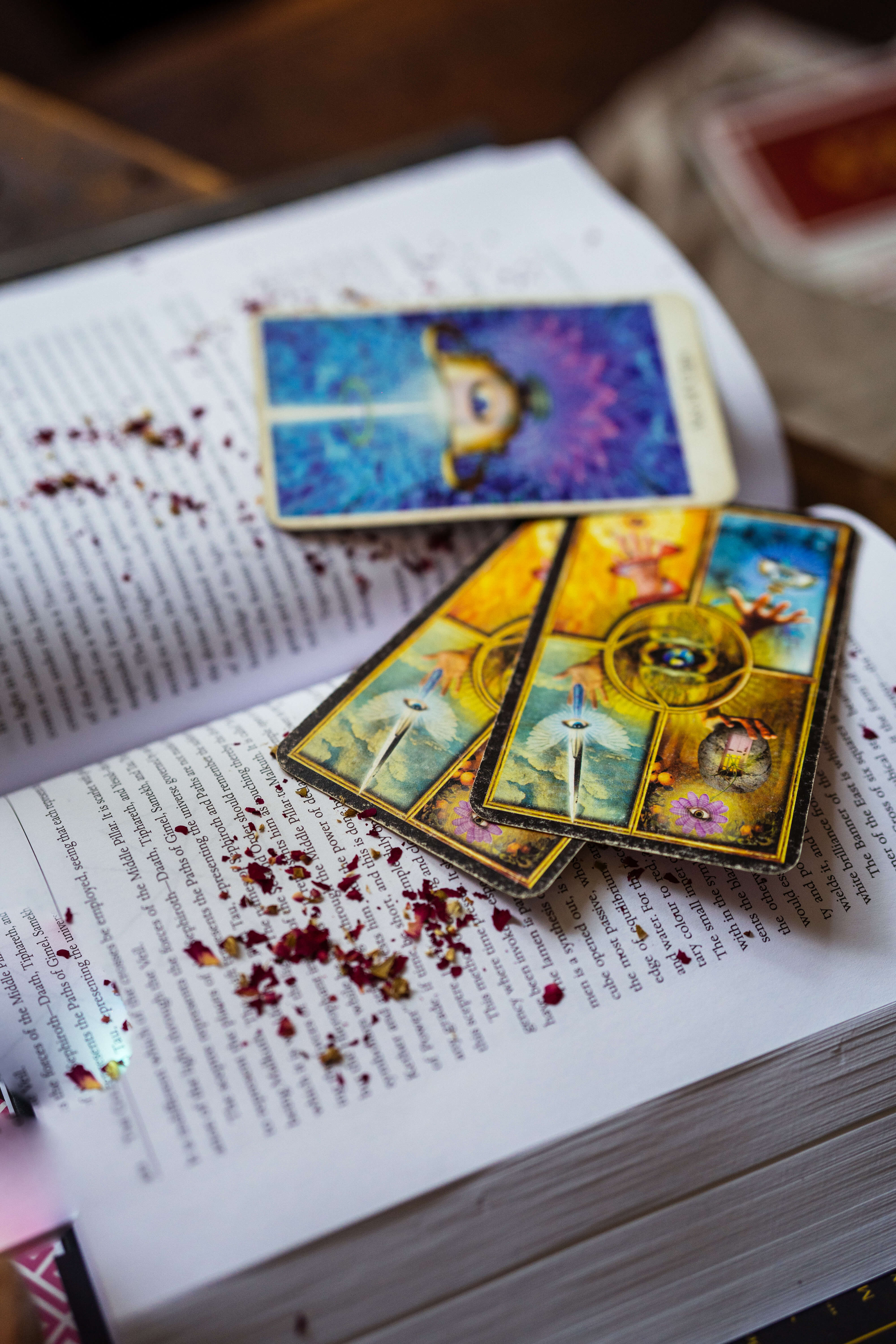 Tarot on a book with rose petals